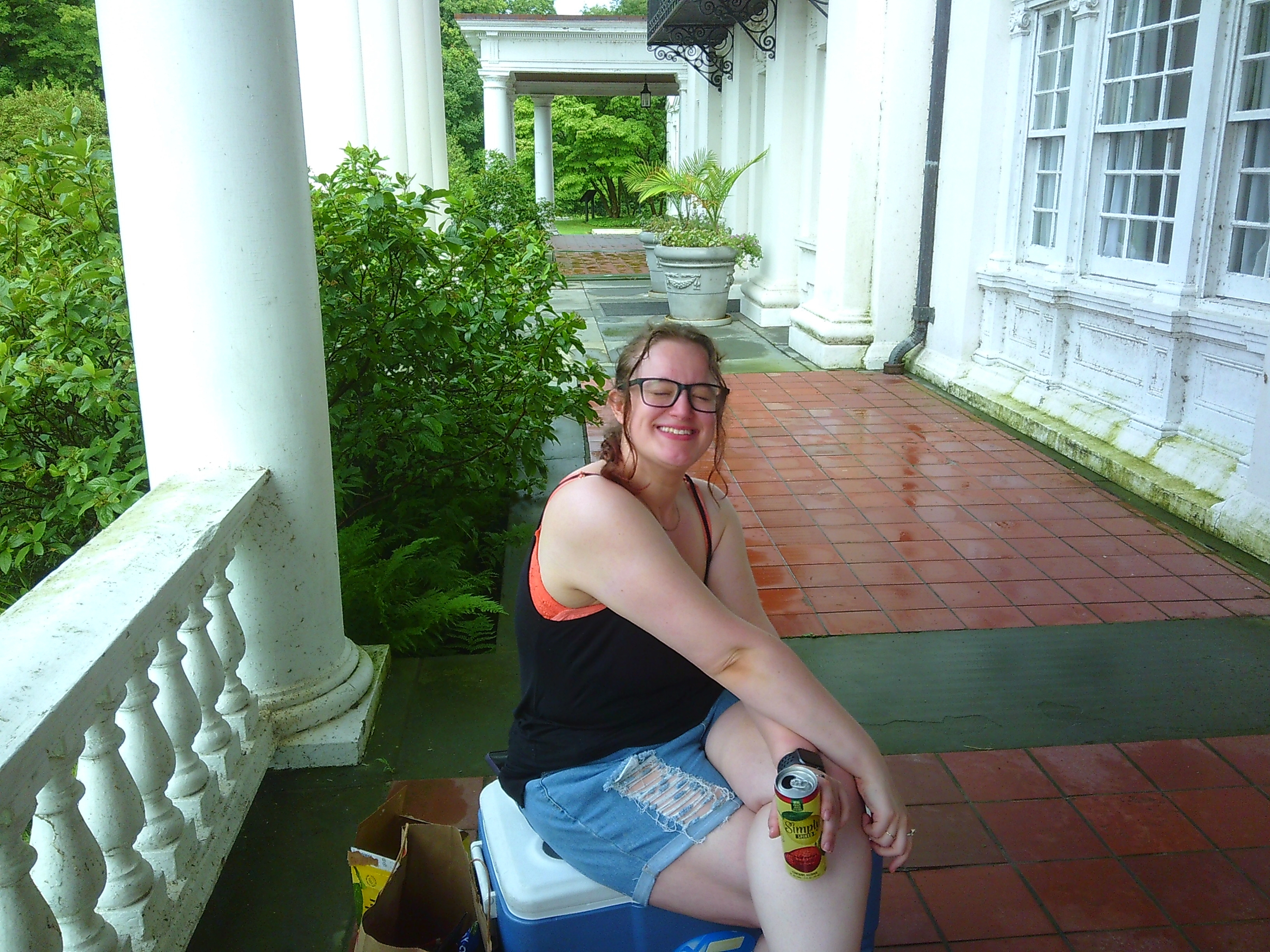 Photo of a woman smiling on top of a cooler