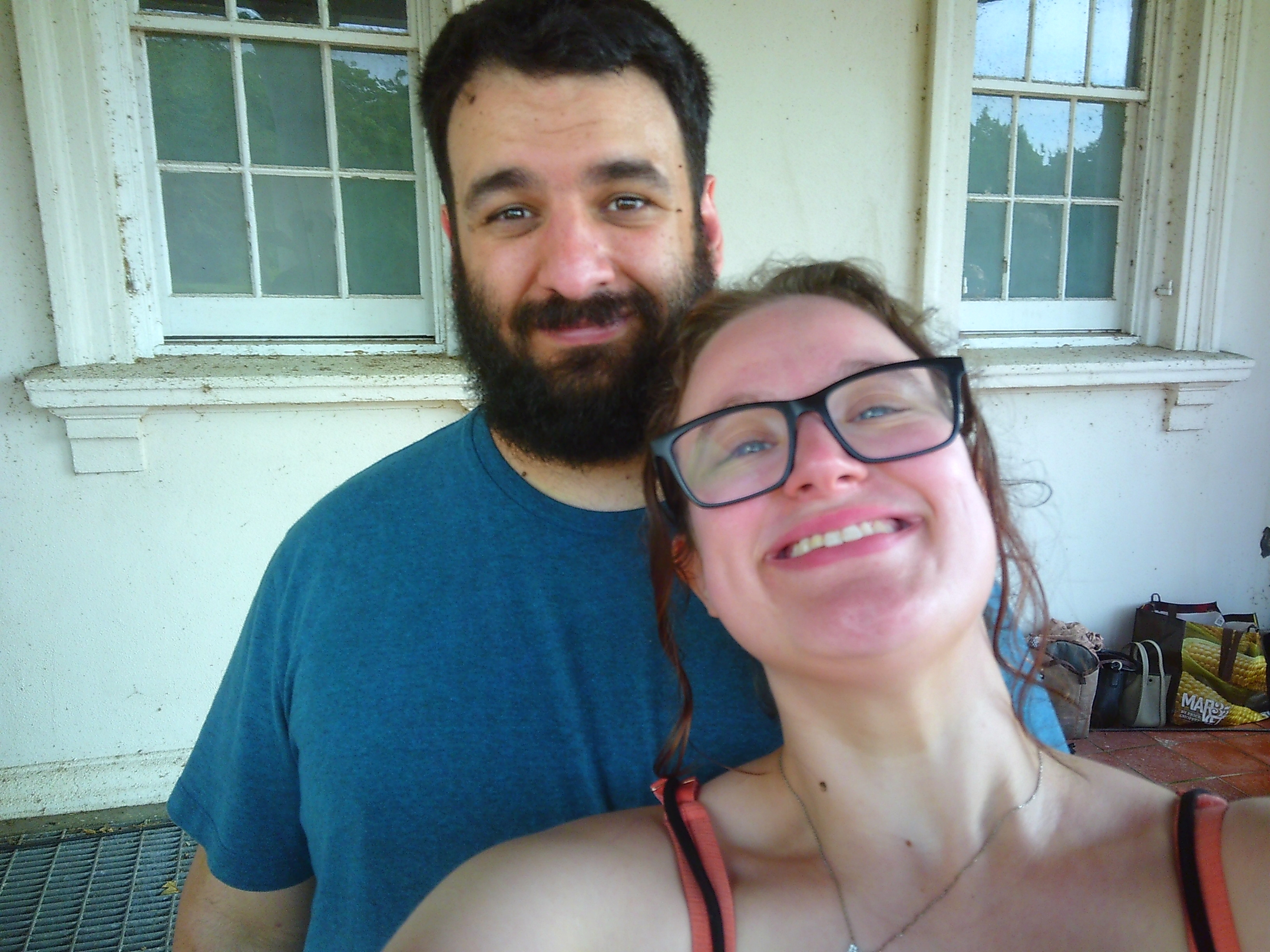 A selfie of both a man and a woman. The woman is smiling, the man looks a bit more stoic