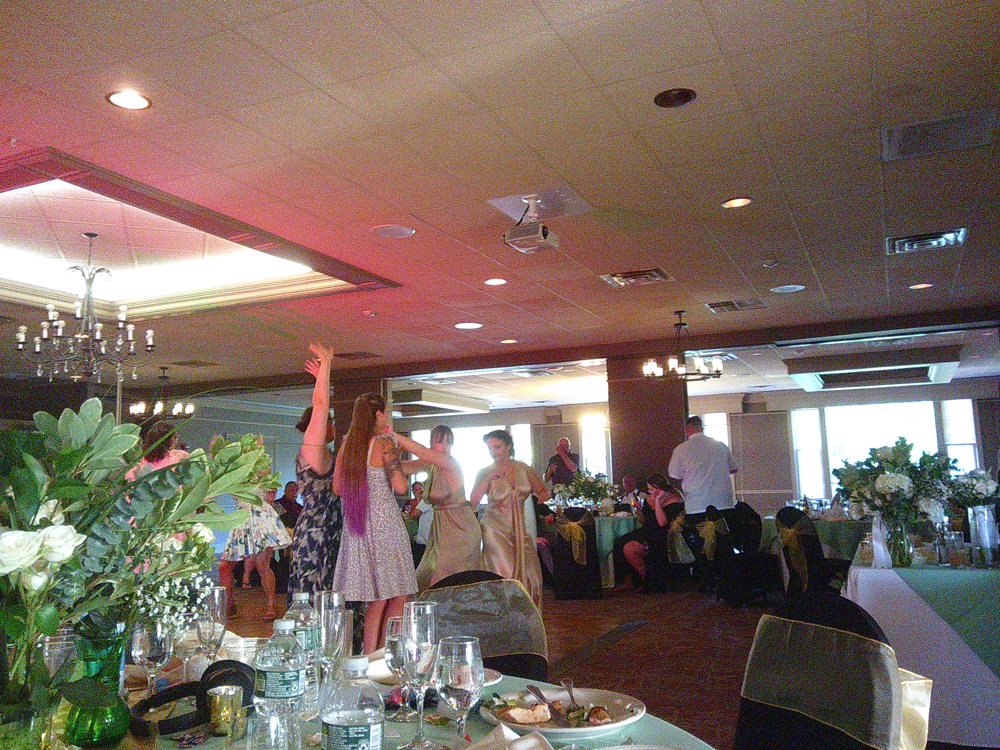 Photo of the bride Zakiah bumping booties with her maid of honor on the dance floor