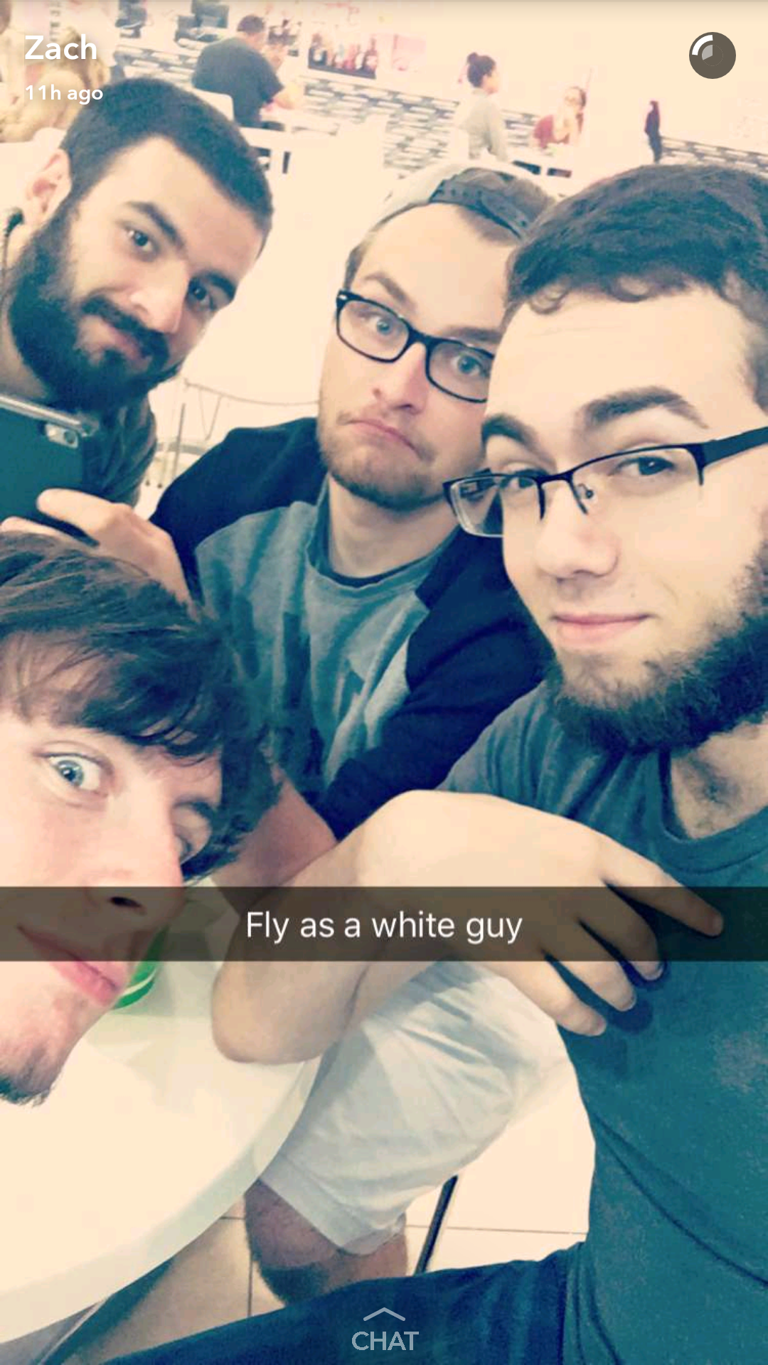 A selfie of 4 people with the caption 'fly as a white guy'. In the back is myself, in the black sleeves and hat is JC, taking the photo is Zach, and the one peering in from the side is John