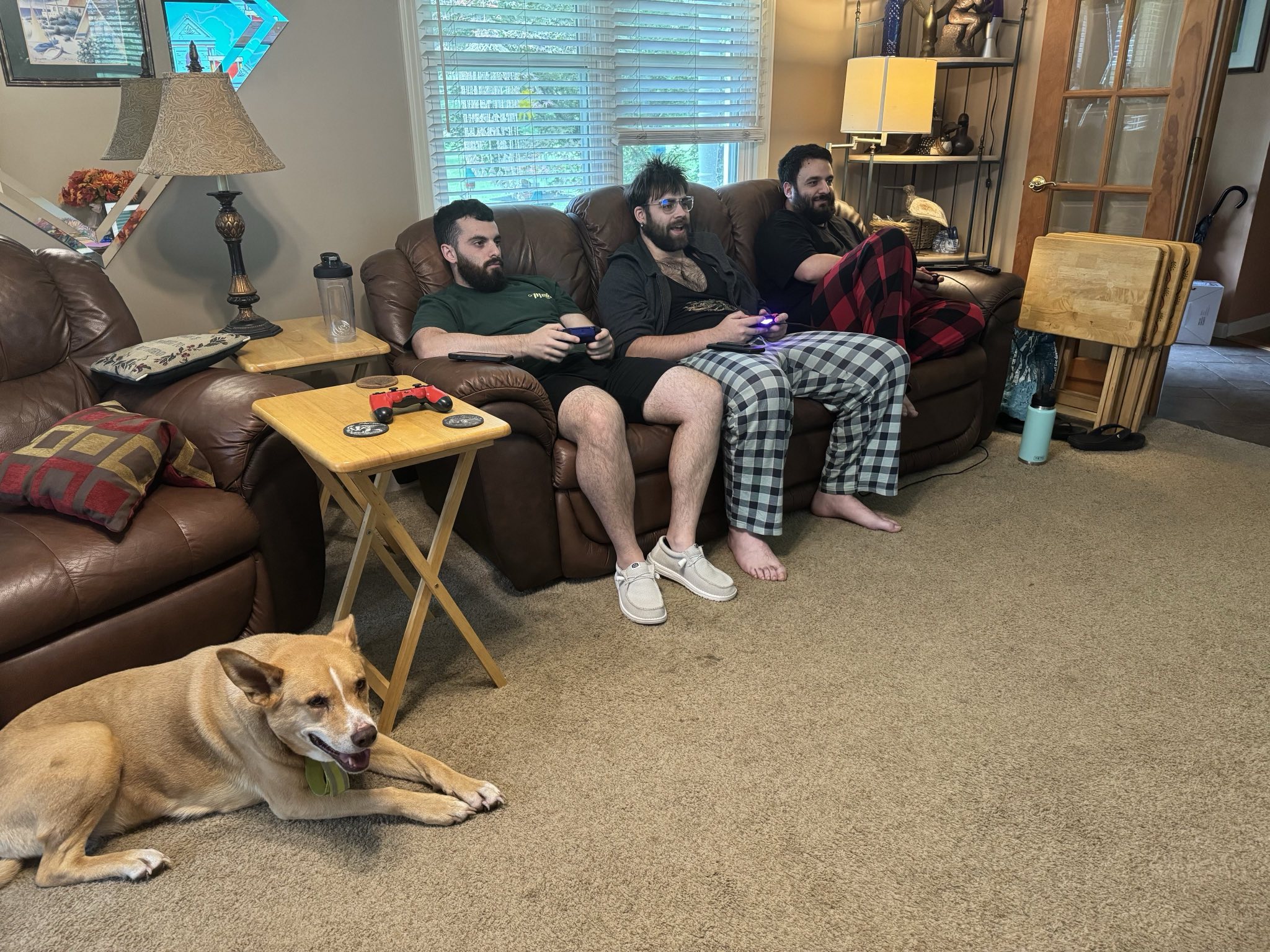 Photo of three adult brothers ranging from 20 to 28 years old on a couch looking more jovial