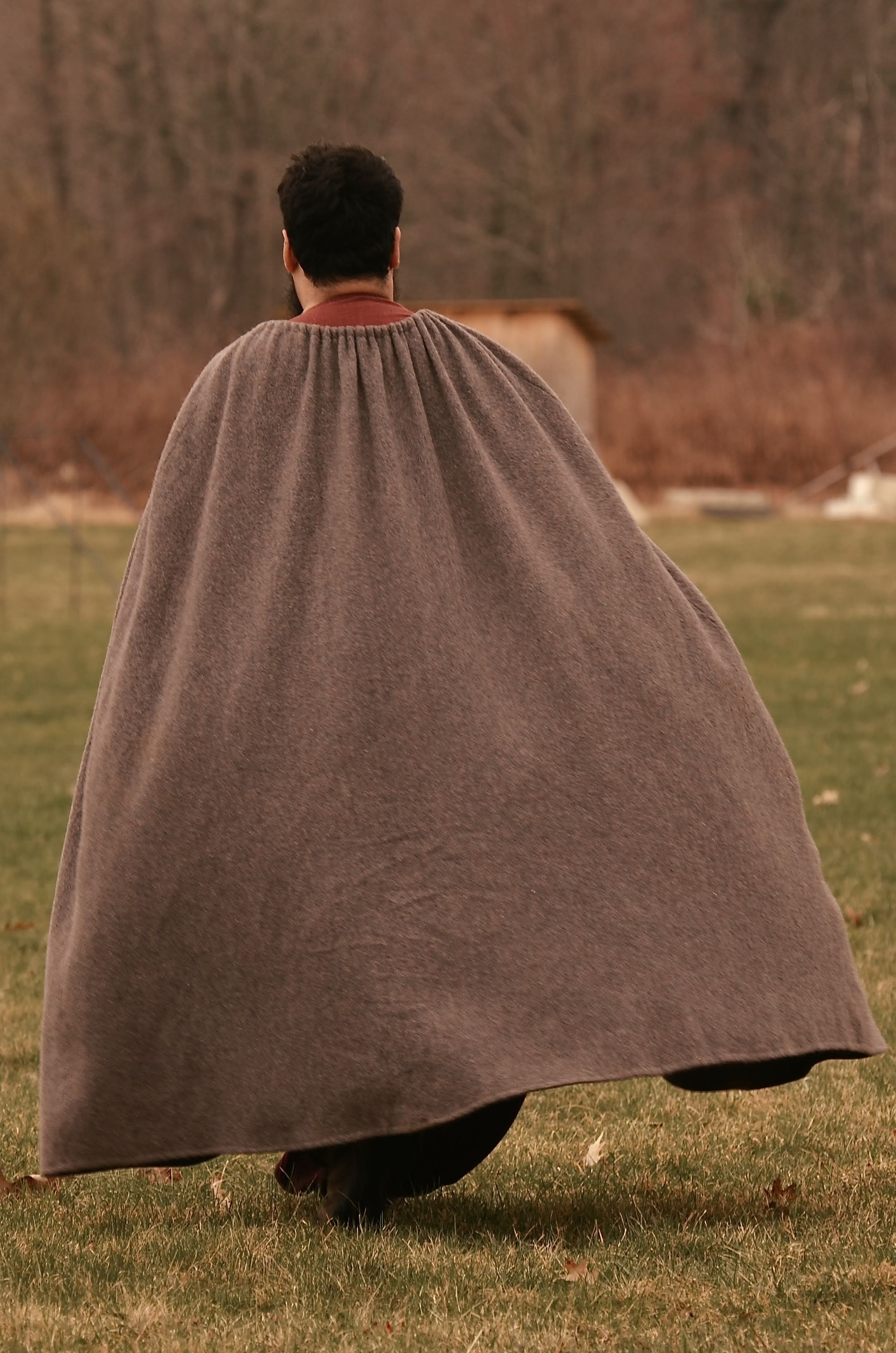 Photo of me walking away, with my wool cloak billowing in the wind