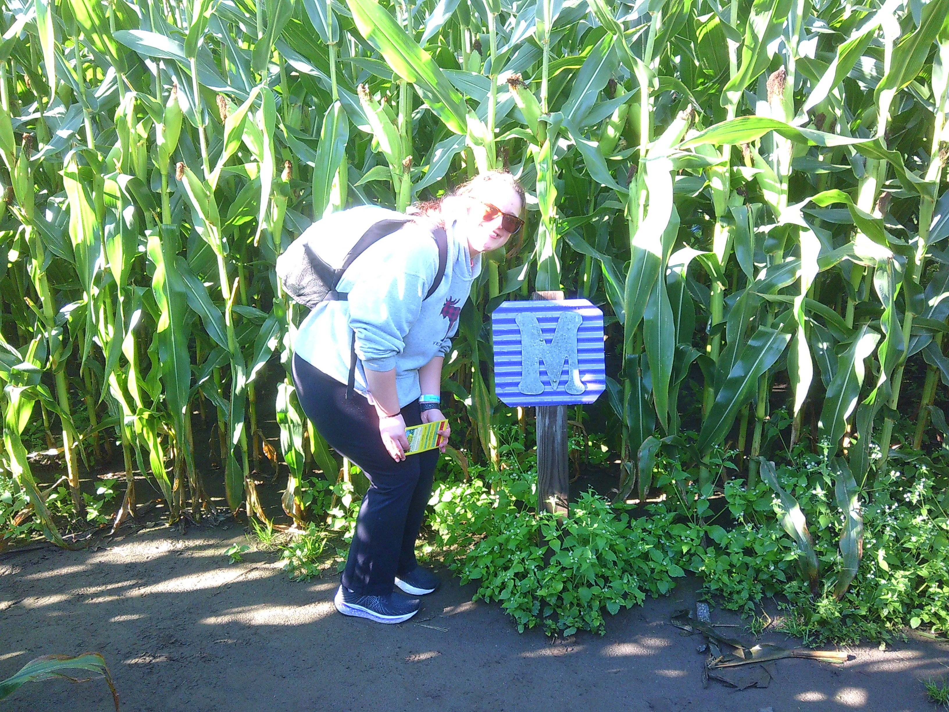 Photo of Michelle standing near the letter M