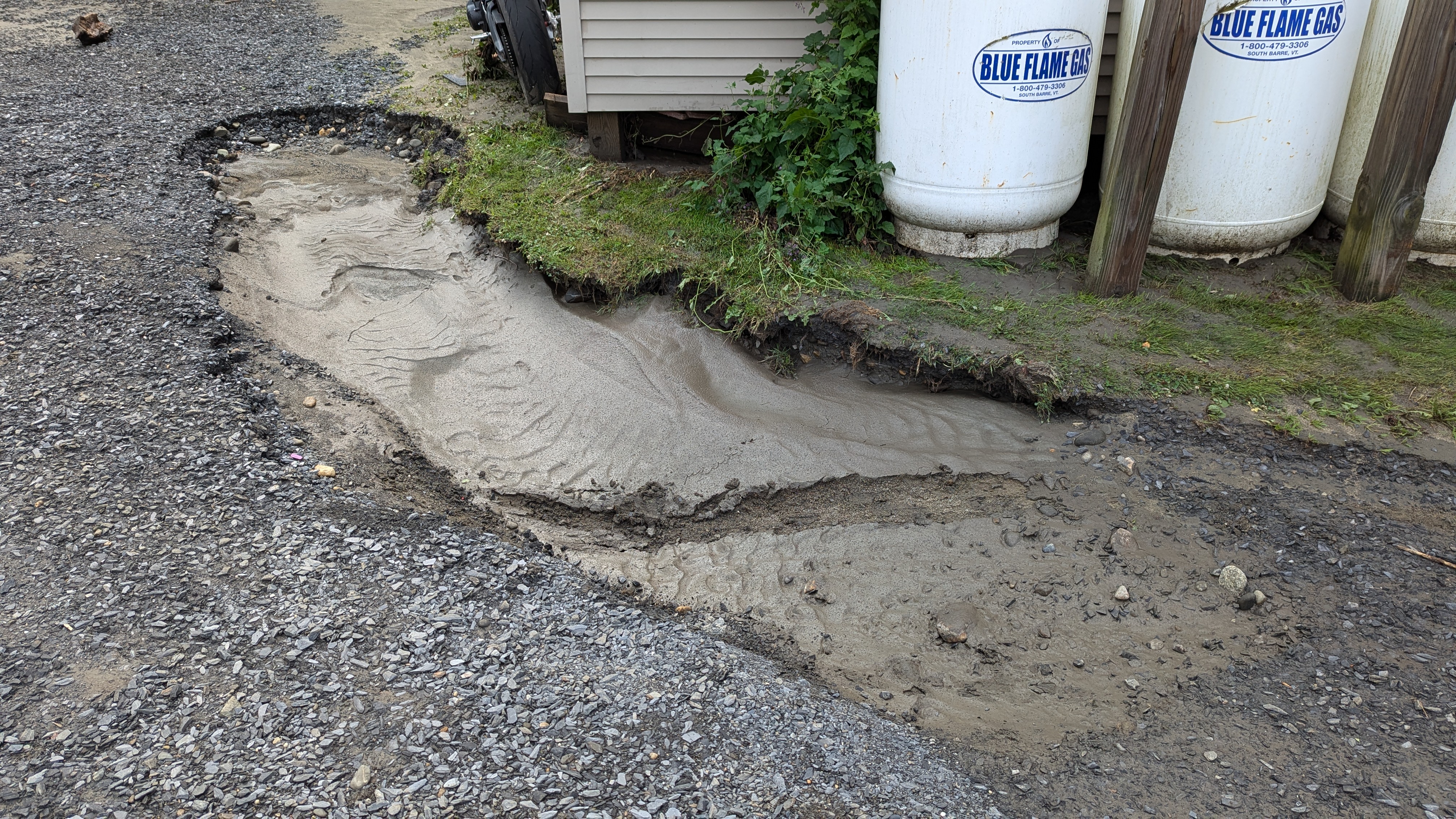 photo of a deep rut with sandy sort of mud in a dirty driveway