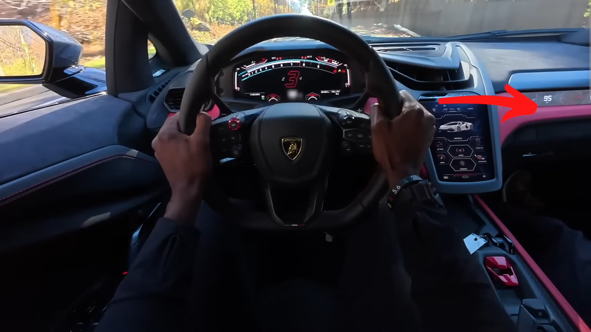 A screenshot from a first person video of MKBHD driving a sports car going 95 mph. You can see past the windshield a yellow sign indicating a kid crosswalk up ahead