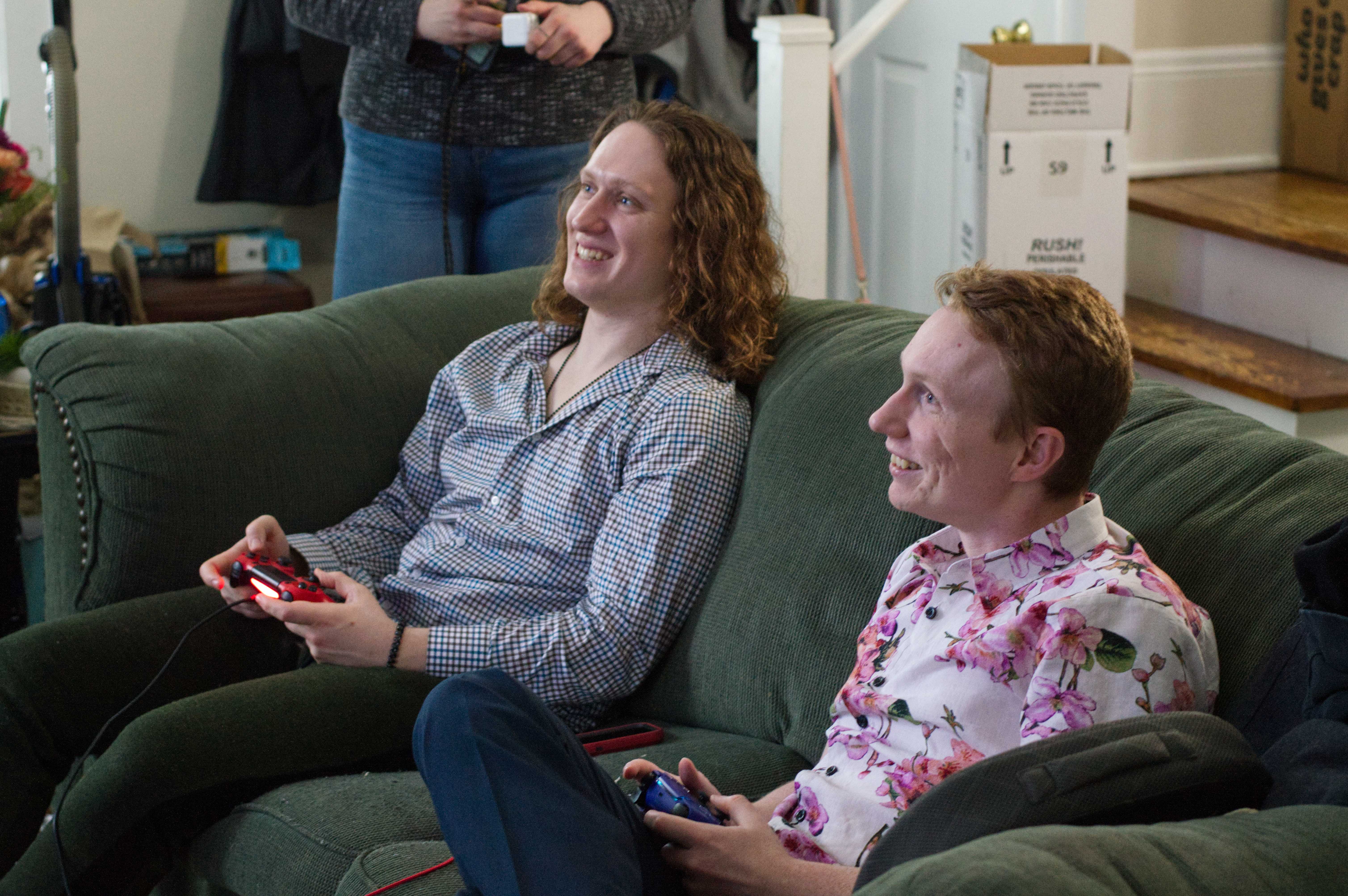 photo of Josh and Mat playing Rivals of Aether. You can see Josh with a red PS4 controller and Mat with a purple PS5 controller. They're both smiling