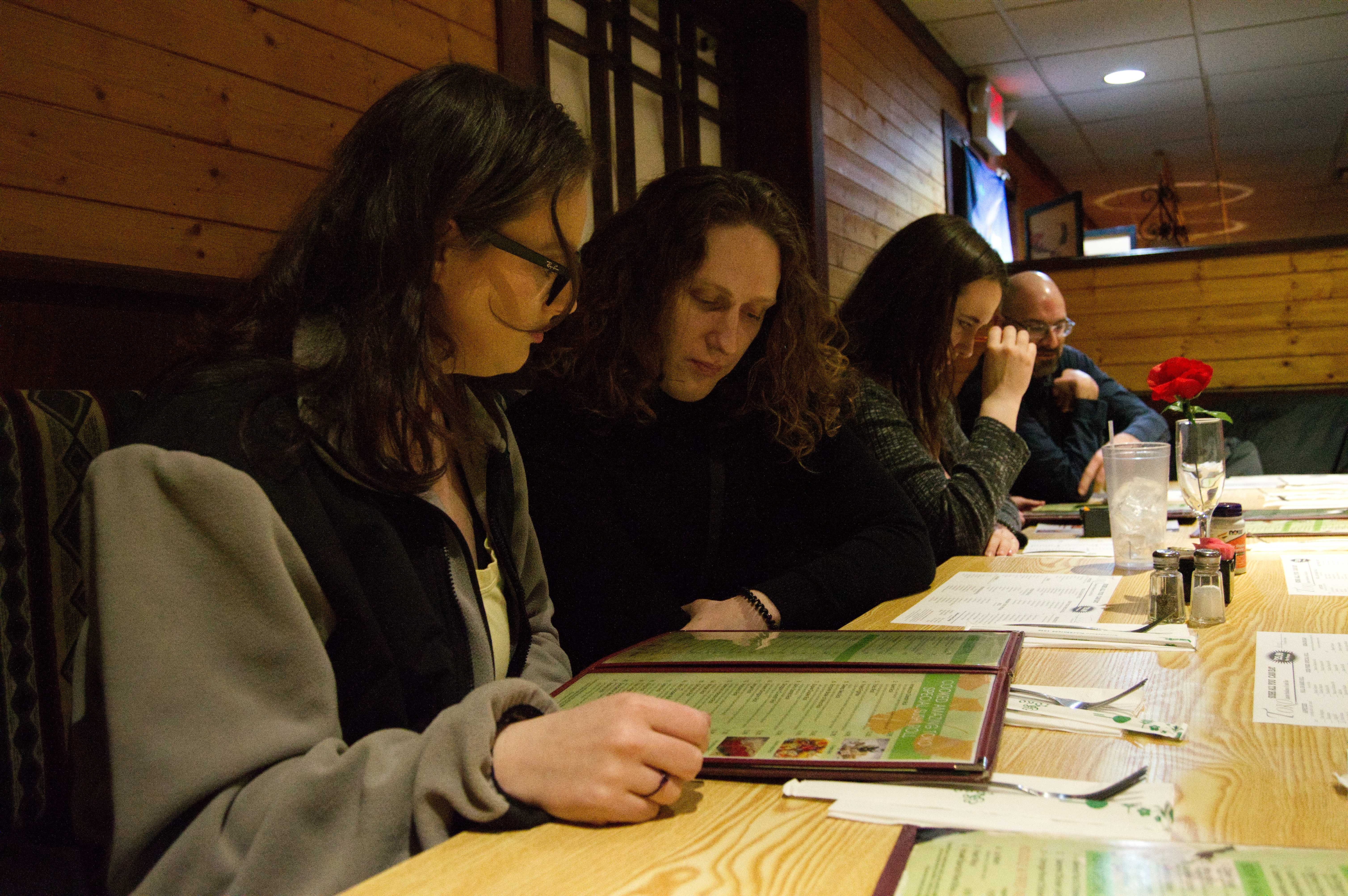 A photo of Michelle and Josh looking over a menu at the sushi restaurant