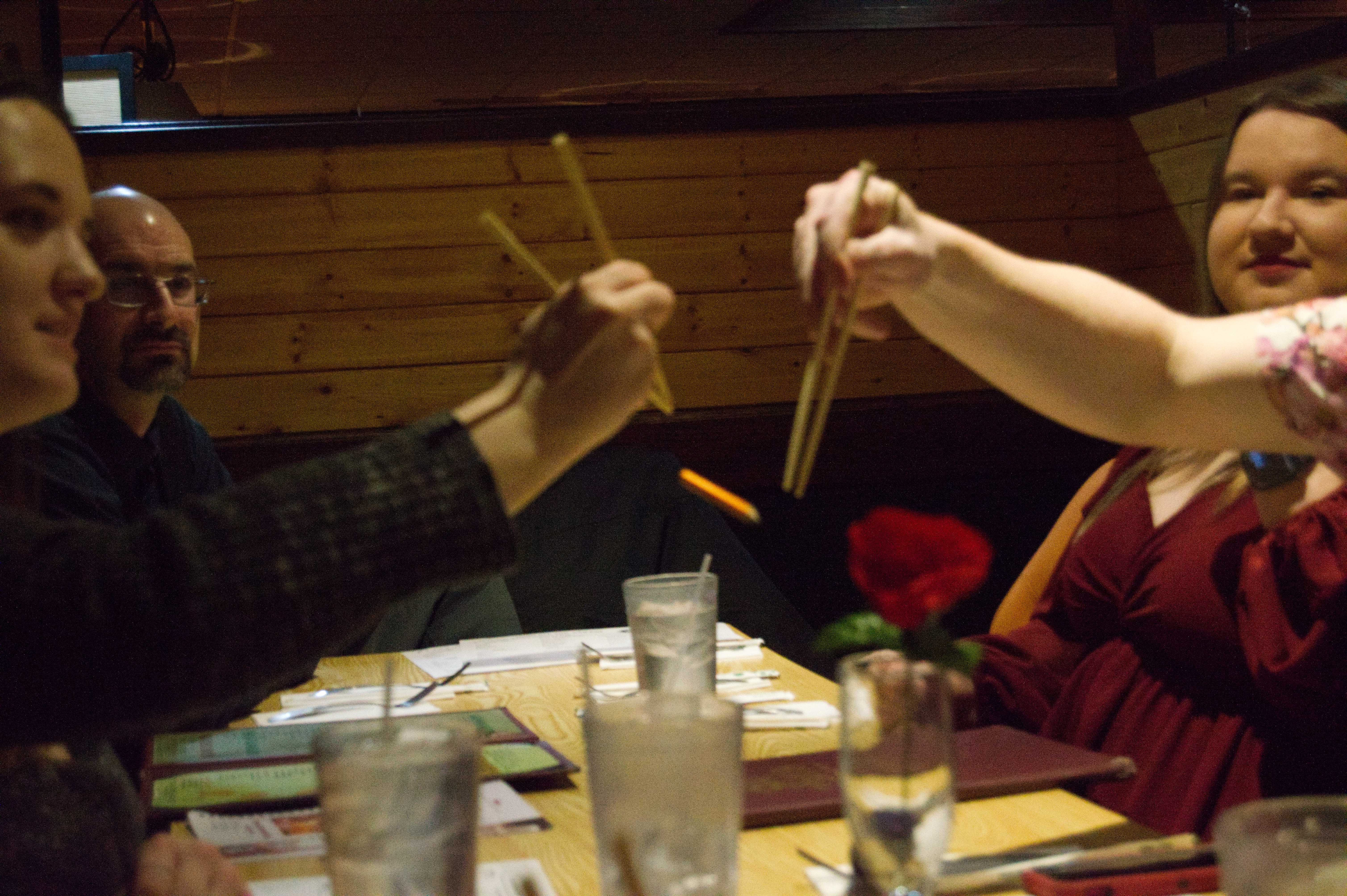 A photo as the pencil falls from mat and Brens chopsticks