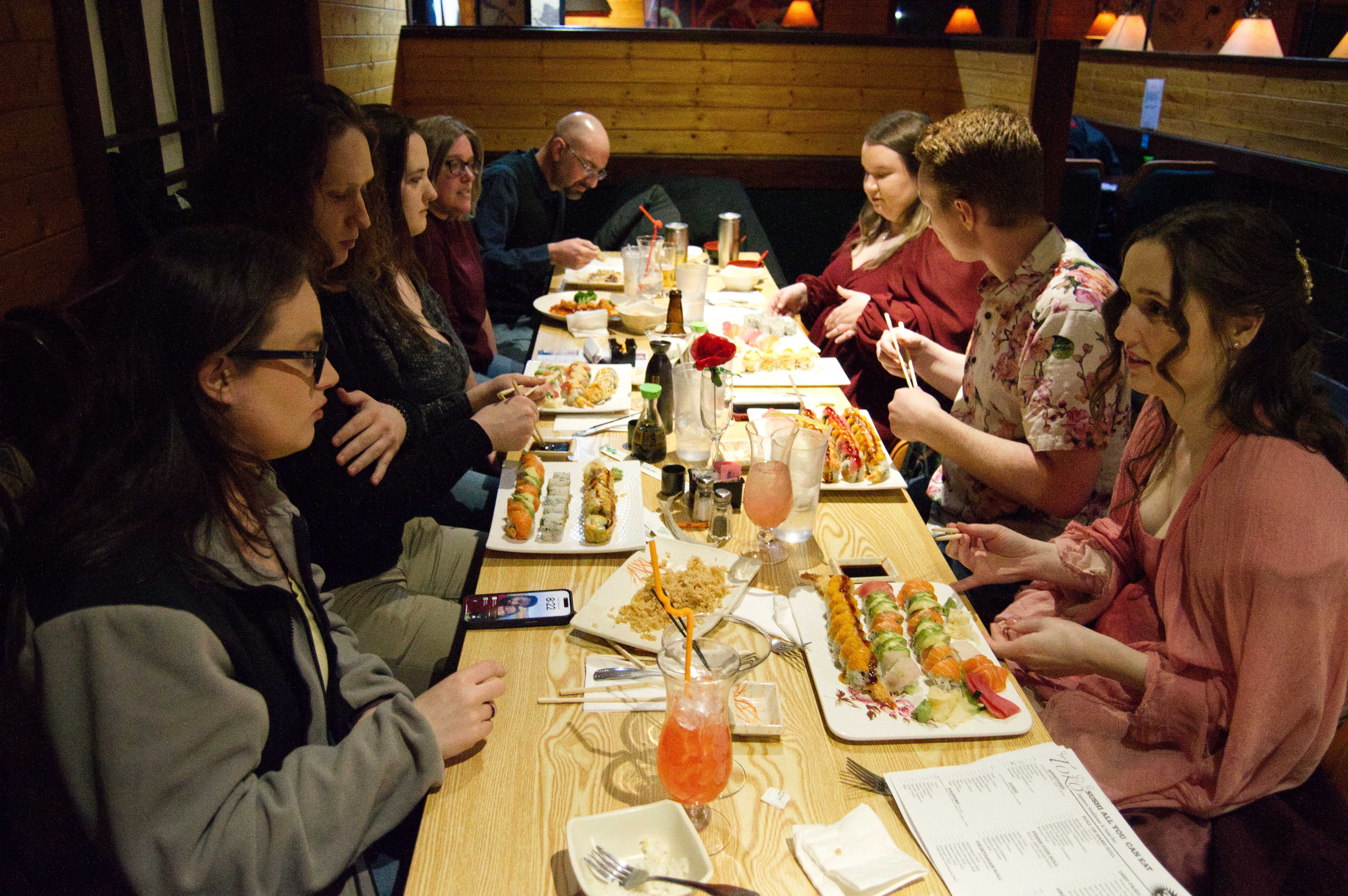 A photo of everyone at the table with their sushi in front of them