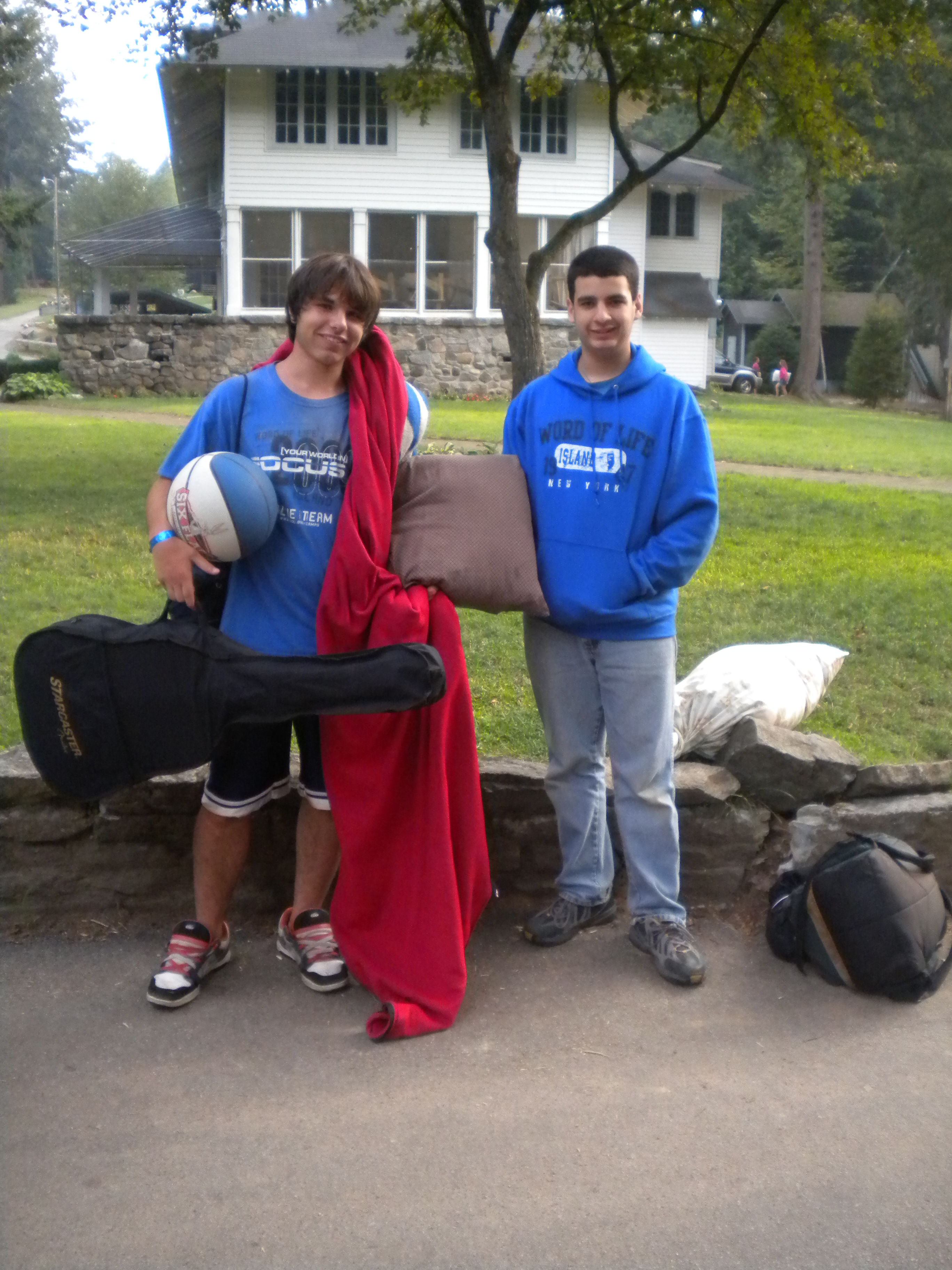 Photo of me as a middle schooler leaving a summer camp, Smiling with another camper, wearing a blue Word of Life sweater