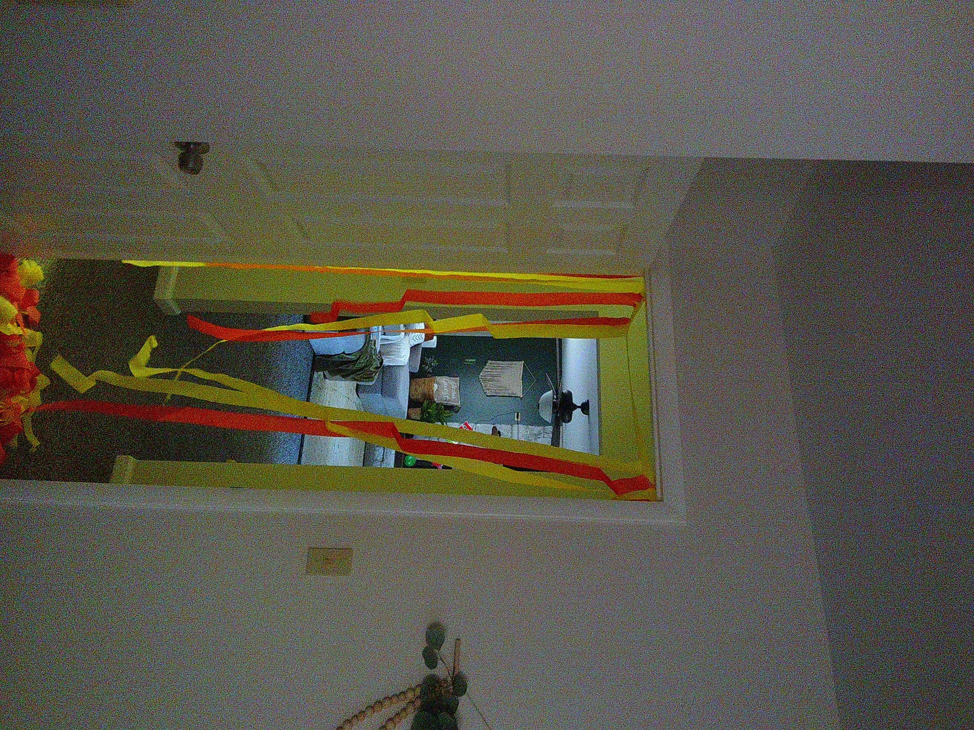 picture of orange and yellow streamers hanging down from a doorway