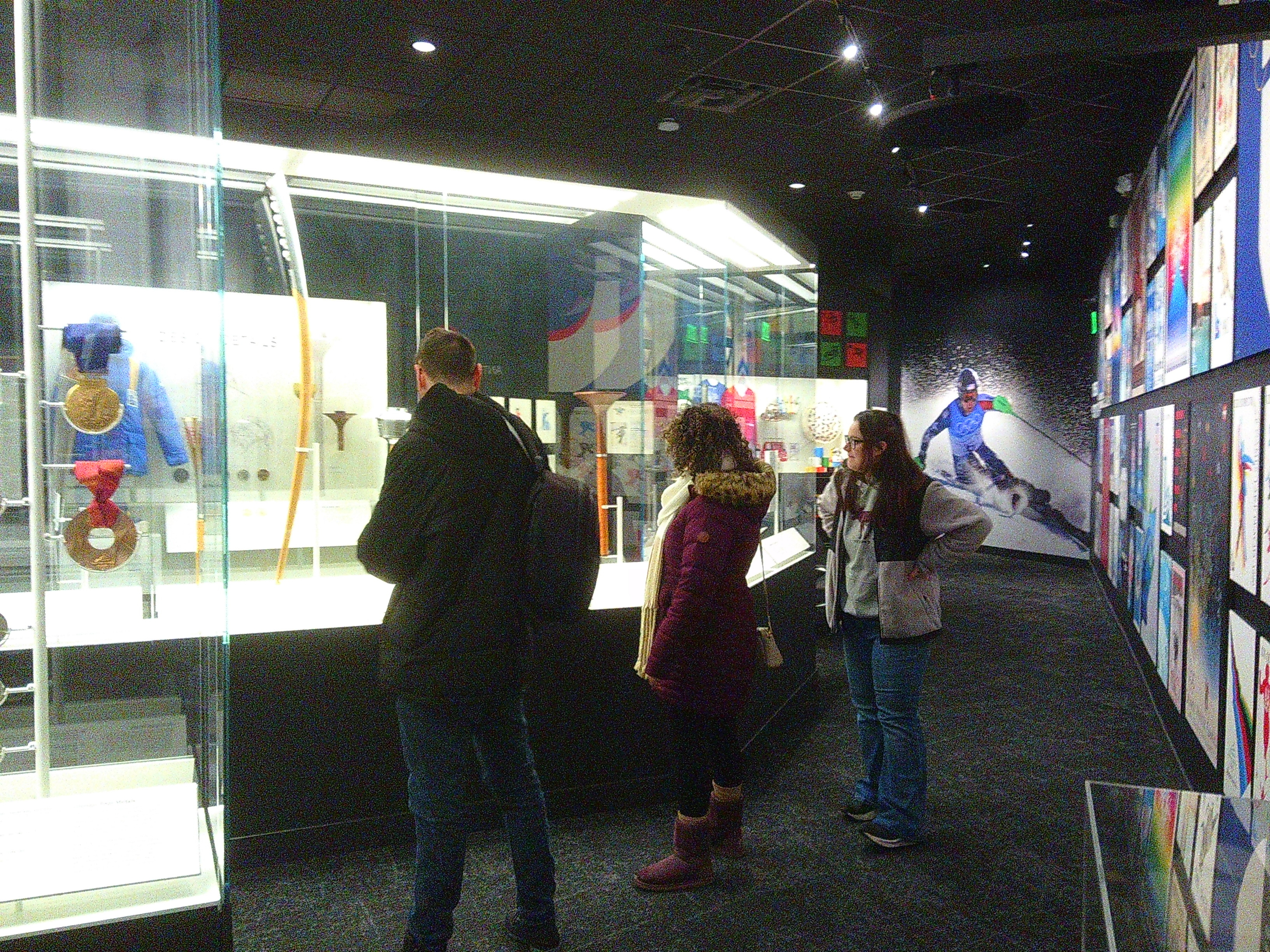 Photo of Tanner, Ali, and Michelle in the Olympic Museum at Lake Placid. They're looking at different torches used at the Winter Games at the Olympics