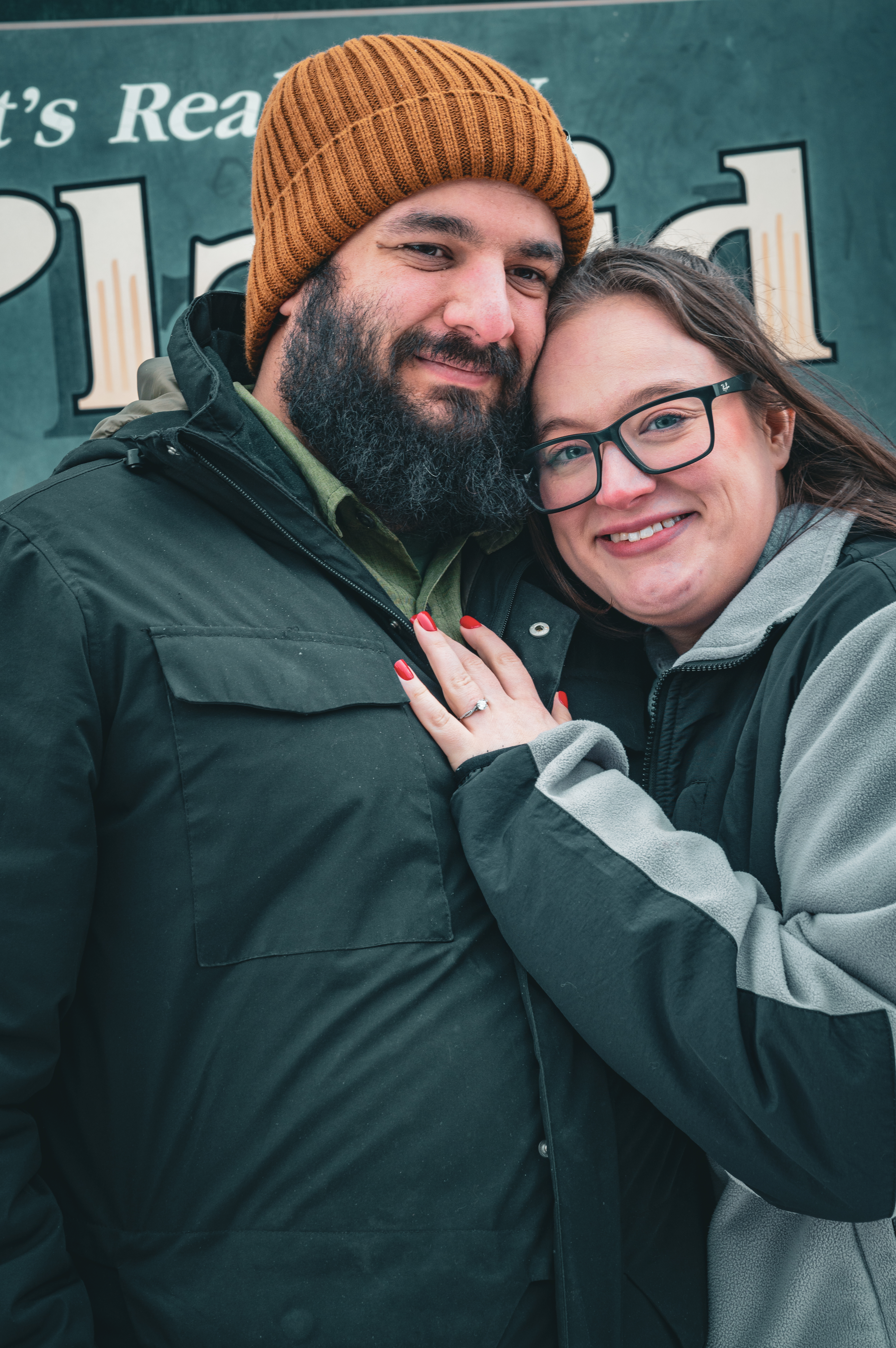 photo of Michelle and I. Our heads are leaning against each other, with Michelle's hand on my chest showing off her ring