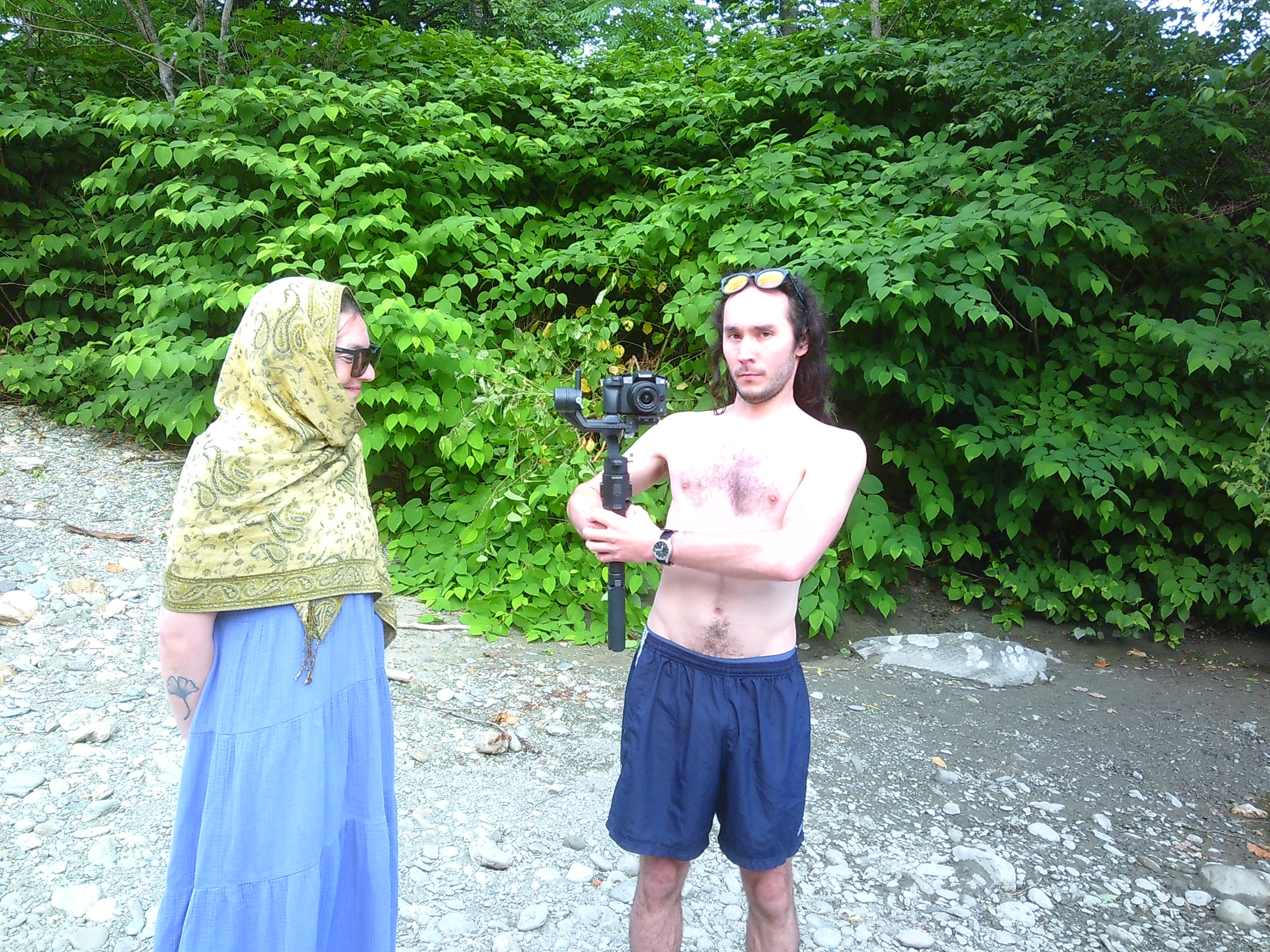 Photo of Sid and Claire where Sid is holding a Lumix G7 camera, sort of like a torch or sword