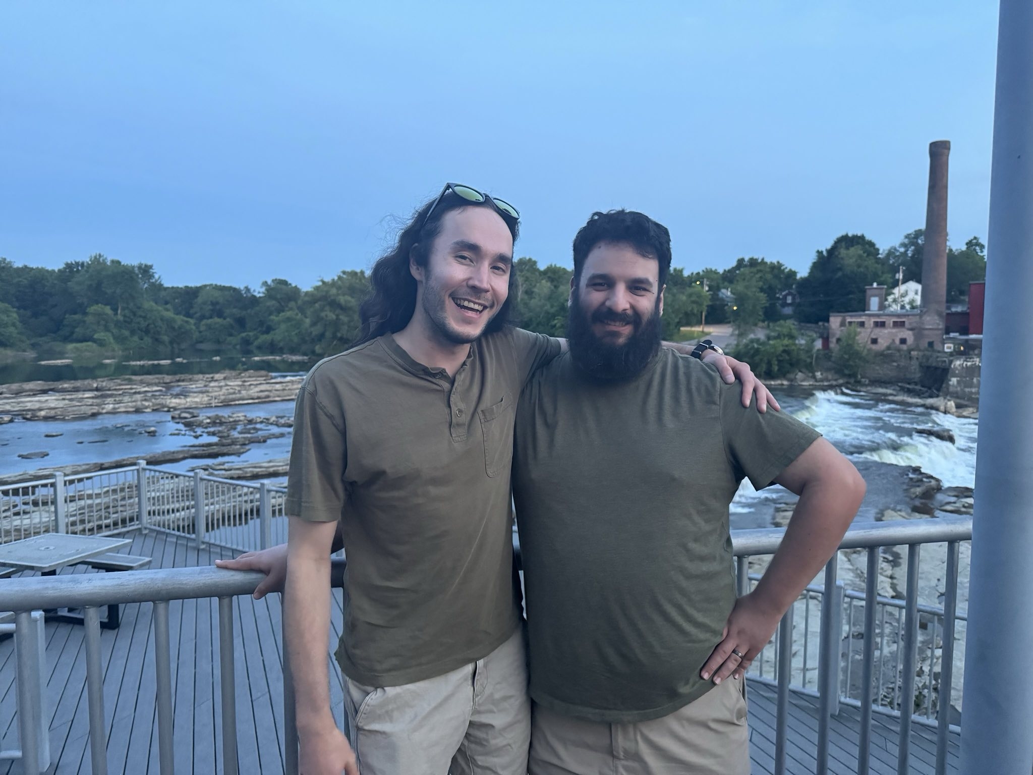 Photo of me and sid with a river and little waterfall behind us