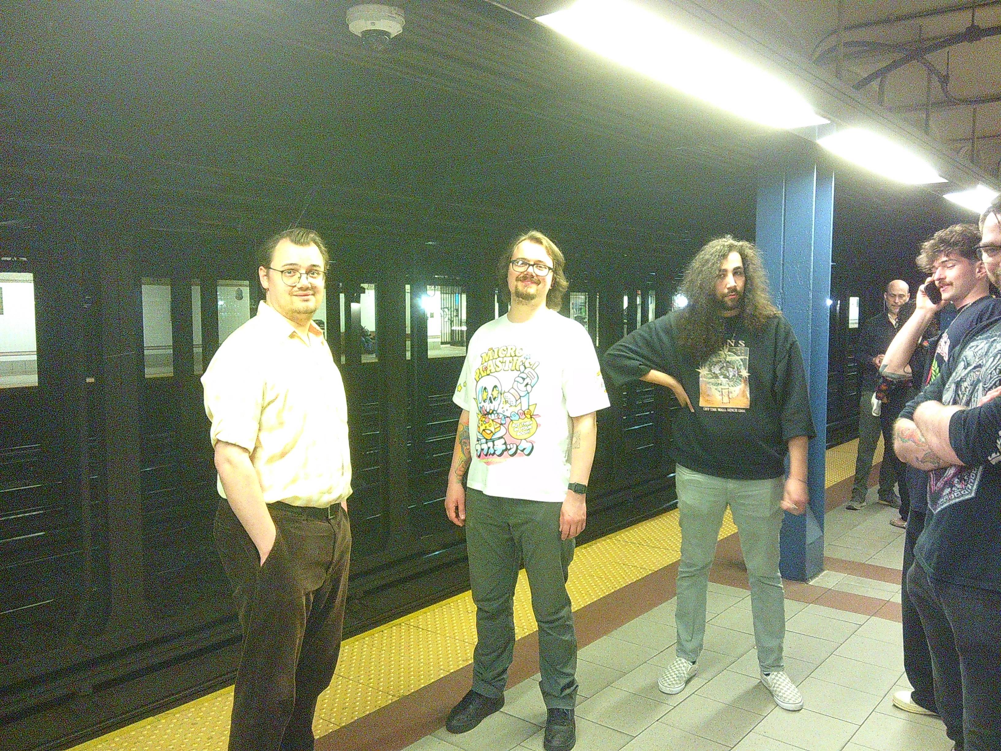 5 men (Dylan, Aiden, Ben, Skyler Tanner from left to right) waiting at a subway stop. Tanner is half cut out of the frame