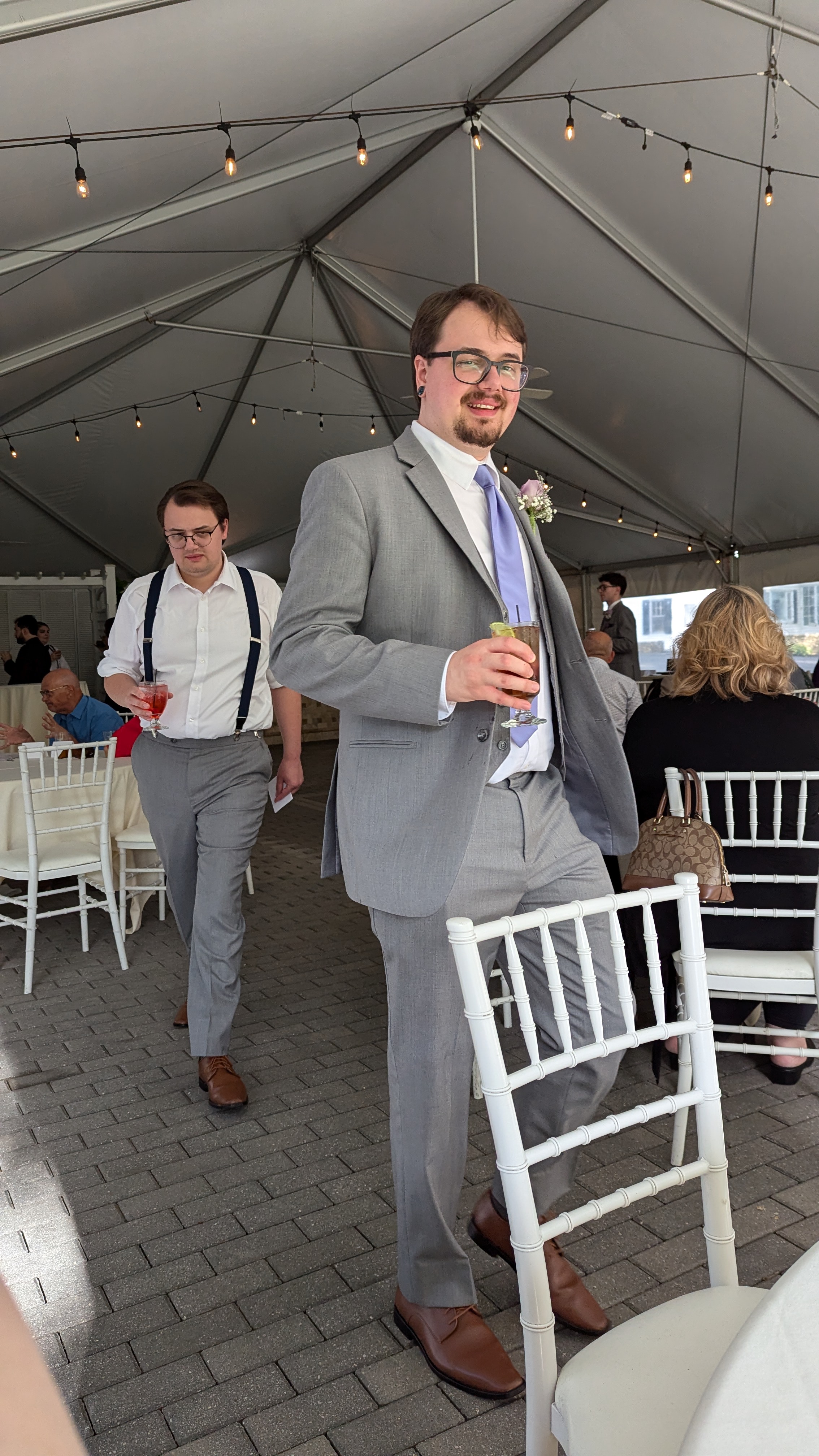 Two men approaching a table with drinks in their hands