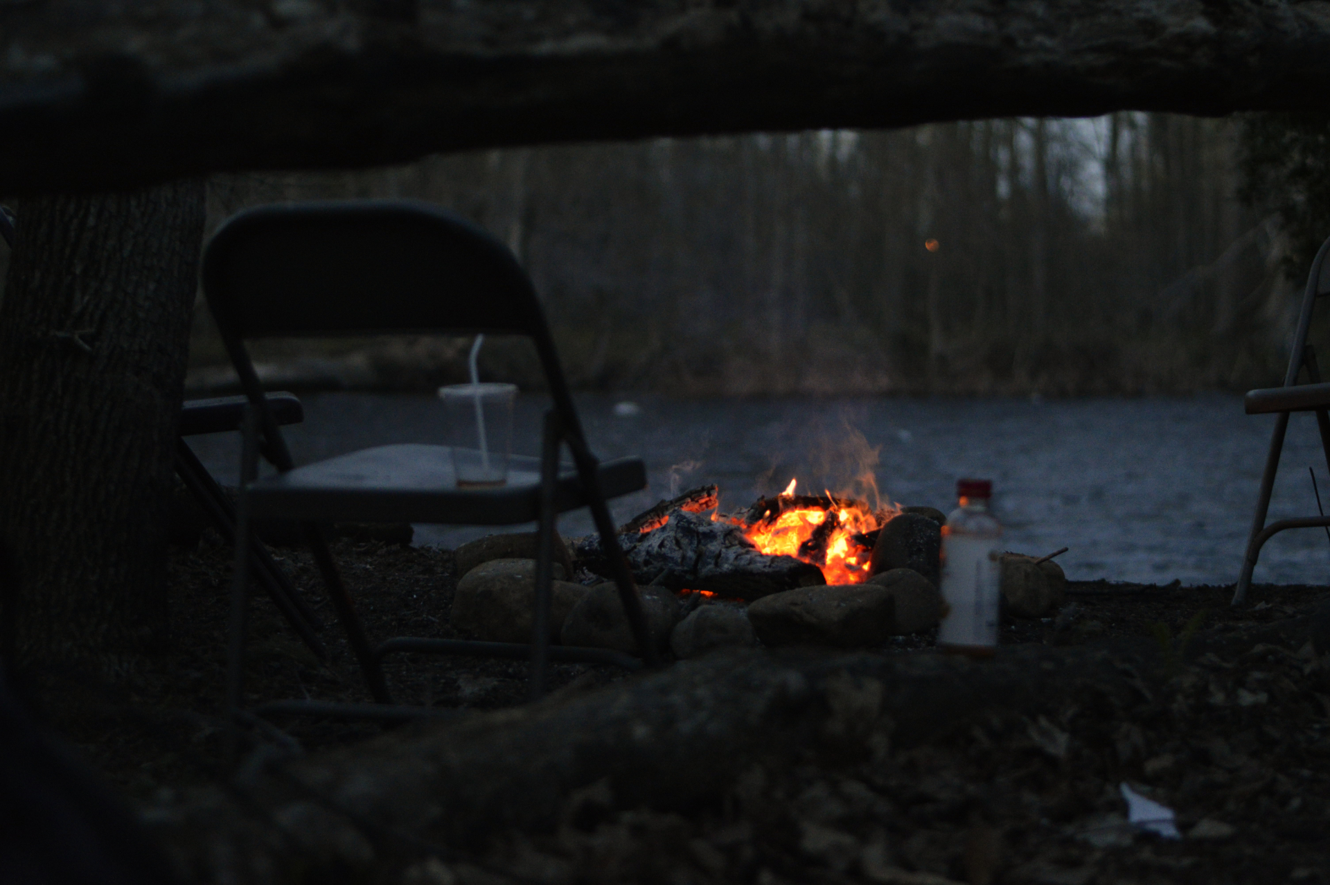 image of some chairs around a campfire