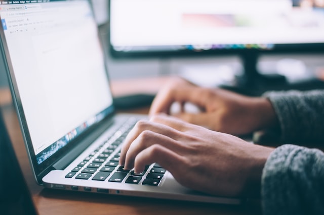 image of person typing on a computer